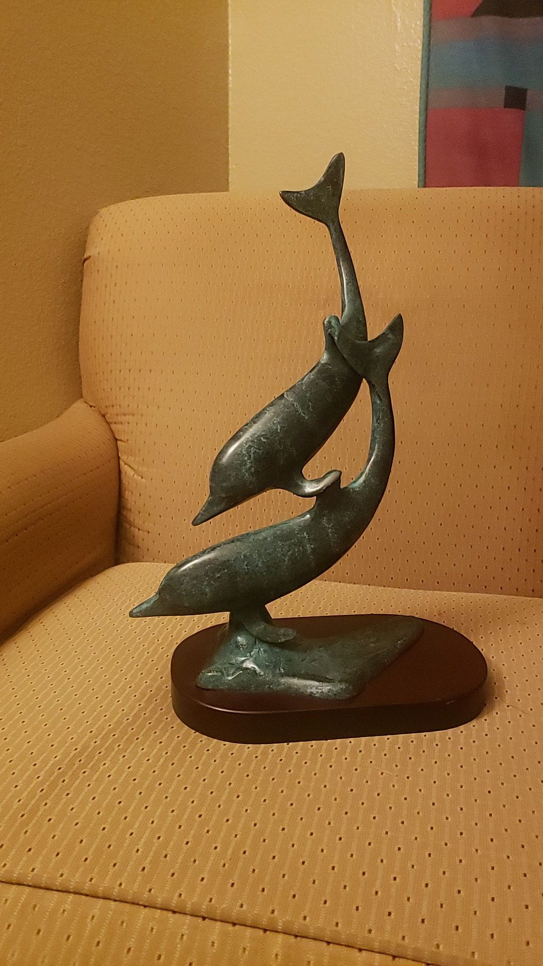 Unmarked solid bronze dolphins swimming silhouette