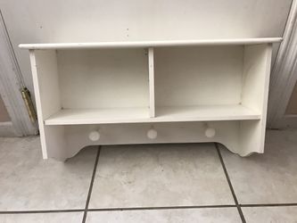 White shelf with storage