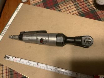 This is a pneumatic air ratchet tool, likely a 3/8" drive model, used for tightening or loosening fasteners with compressed air.The tool features a le