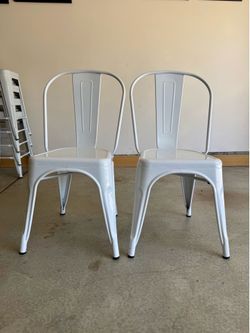 Two White Metal Chairs