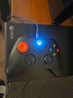 Xbox One with controller and flat screen TV