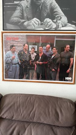 A framed poster of the cast of the television series "The Sopranos".2001