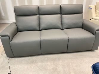 New Dual Power reclining Sofa gray leather by Nisco.