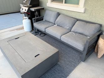 Outside couch + rock fire place + rug