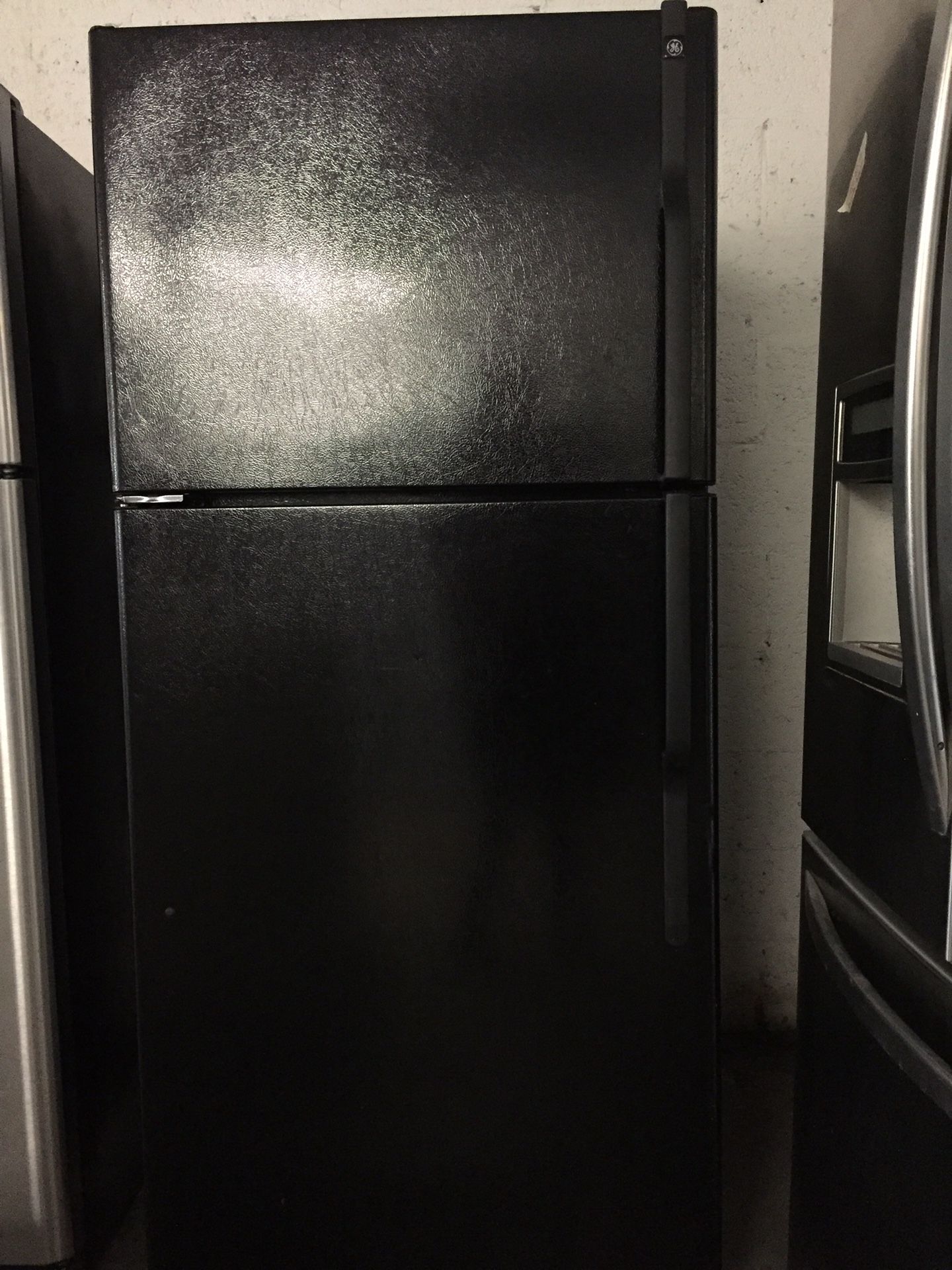 Black top freezer refrigerator brand GE