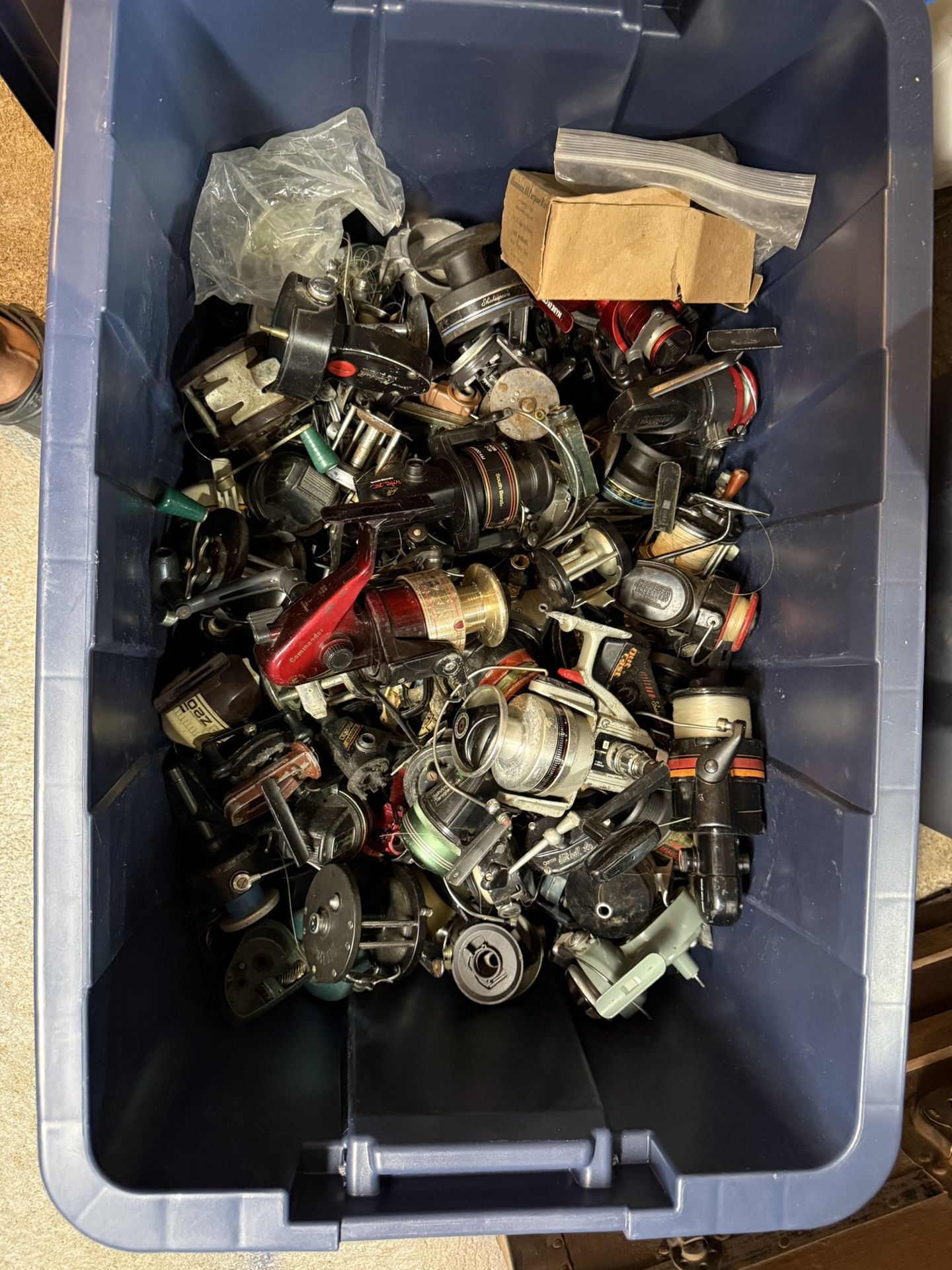 BIN OF FISHING REELS AND PARTS