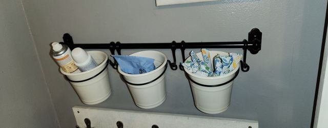 The IKEA FINTORP White Enamel Bucket With Black Handle Hanging Ring. Size of 5 inches in height makes it ideal for storing small items, while the hang