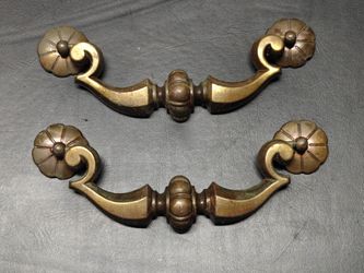 vintage brass drawer pulls featuring ornate floral rosette ends