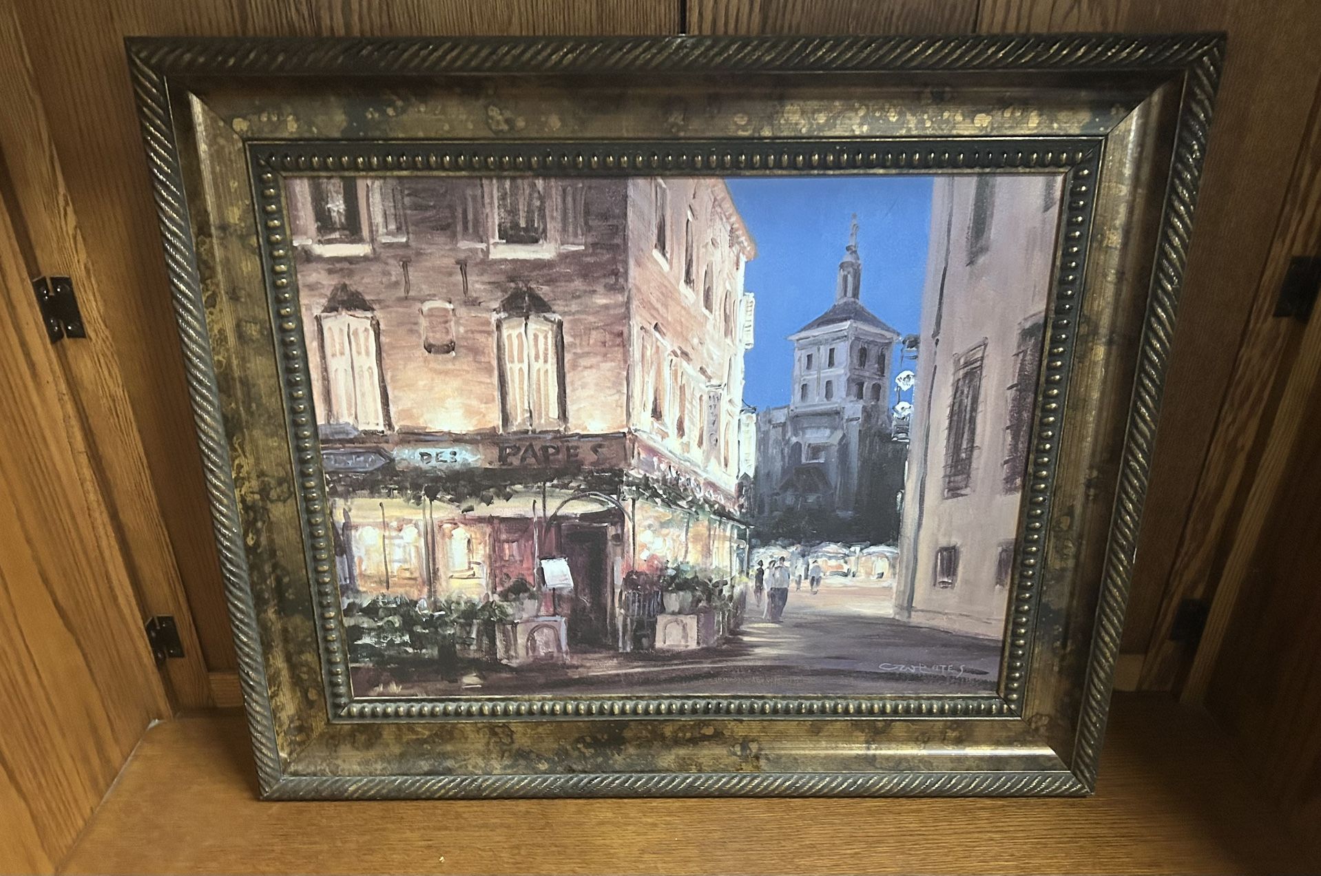 The image displays a framed print of the painting titled "Evening Cafe" by George Bates