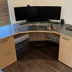 Spacious computer desk with built-in file drawers and cabinet storage