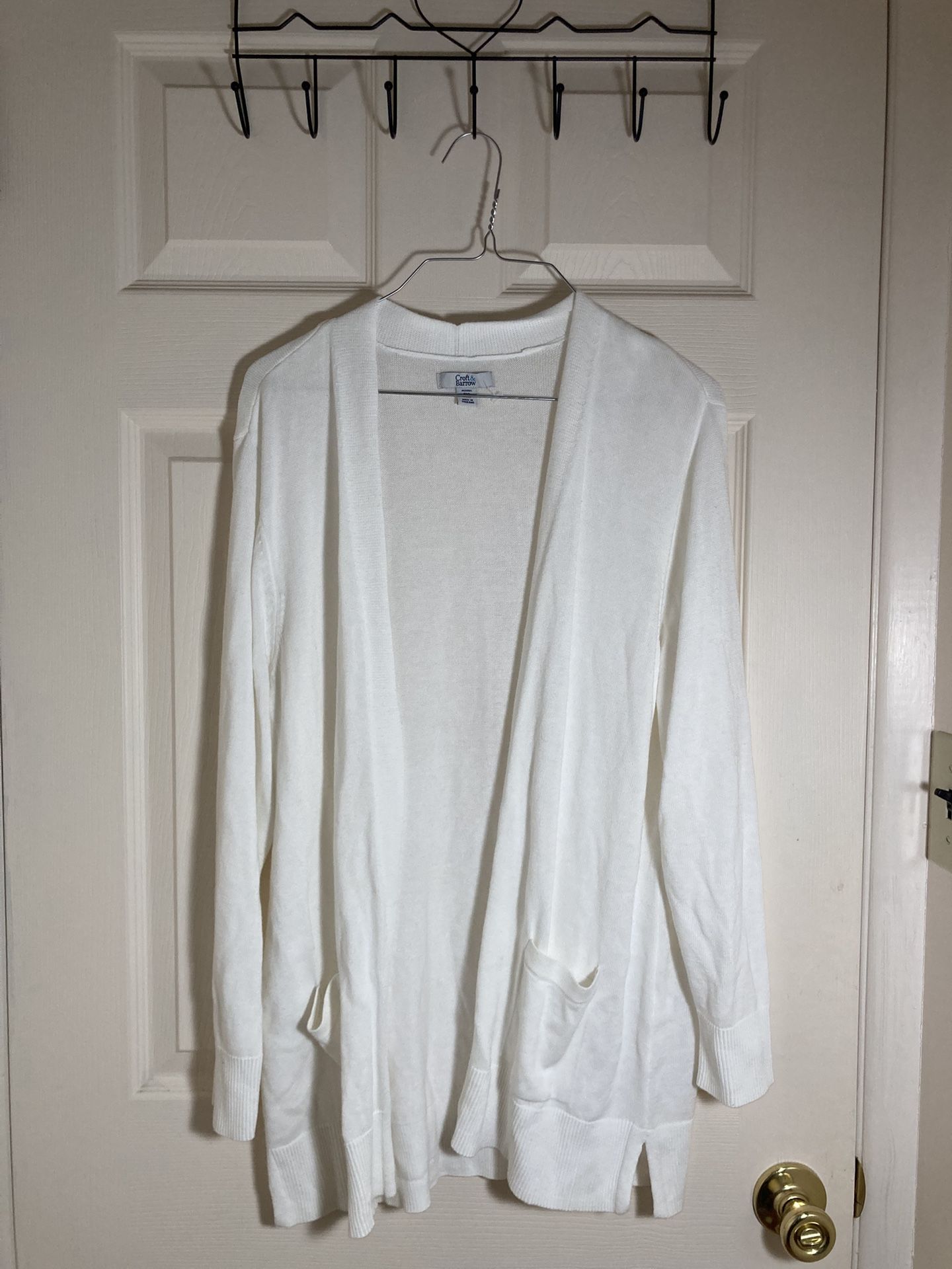 A white cotton cardigan with two pockets