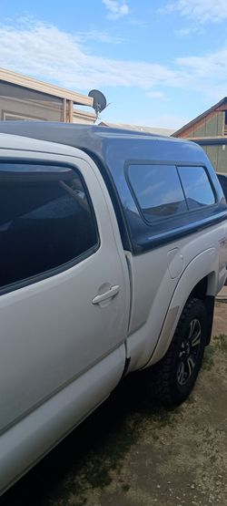 Camper shell Snug Top, for Toyota Tacoma long bed 6 ft, very spacious and tall very  unique, front window goes down has two latches to secure it