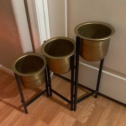 Black metal and gold plant stand and pots