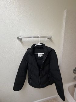 Black cushioned jacket with hood.