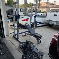 Bench press/squat rack with 7ft 40lbs bar and 205lbs of Olympic rubber weight and curl bar