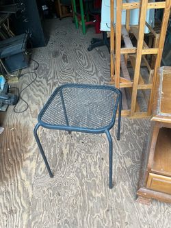 Black Metal Mesh Outdoor Side Table it’s 18 inches tall and 14 by 14 inches across the top