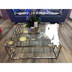Coffee Table with a clear tempered glass and polished stainless steel frame.
