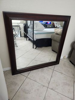 48 in by 48-in hanging wall mirror with a 4-in wood trim $27.50-- Firm