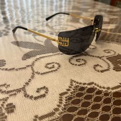 Miu Miu Women's Black and Gold Sunglasses