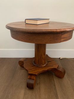 Antique oak round pedestal side  table with carved base.