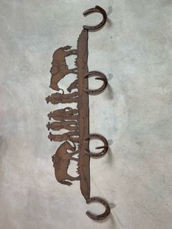 Metal cowboy horseshoe rack