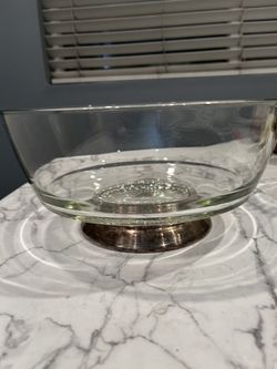a vintage serving bowl, likely a mid-century piece similar to designs by Dorothy Thorpe, featuring a clear glass body on a silver-plated pedestal base