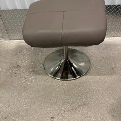 Gray Leather and chrome foot rest… 19” wide, 16” depth, 17” high $40