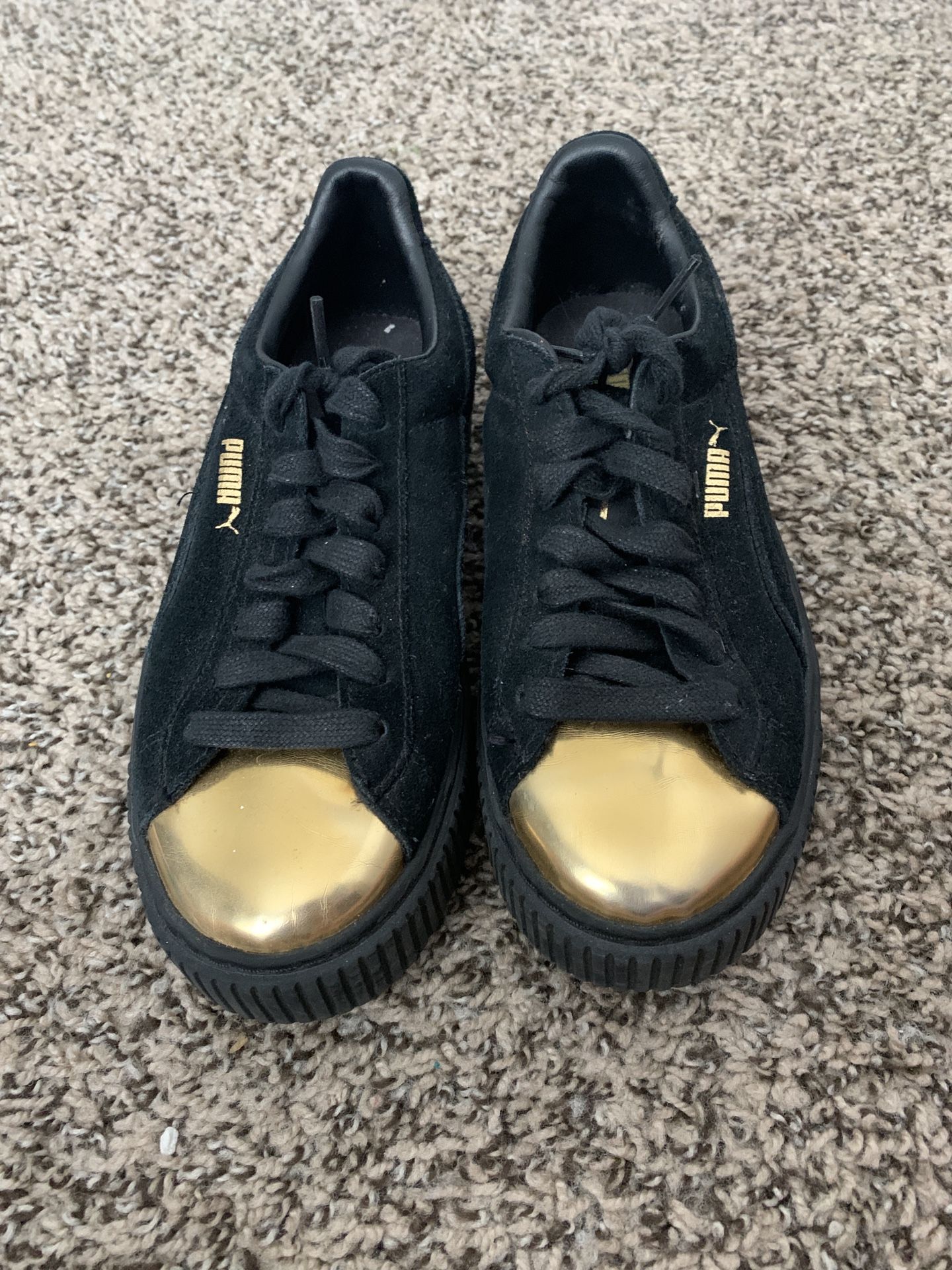 Black and gold pumas size 7