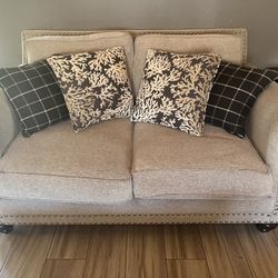 Tan Couches With Blue Pillows