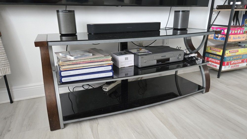 Modern glass TV stand with two shelves for storage.
Tavares FL