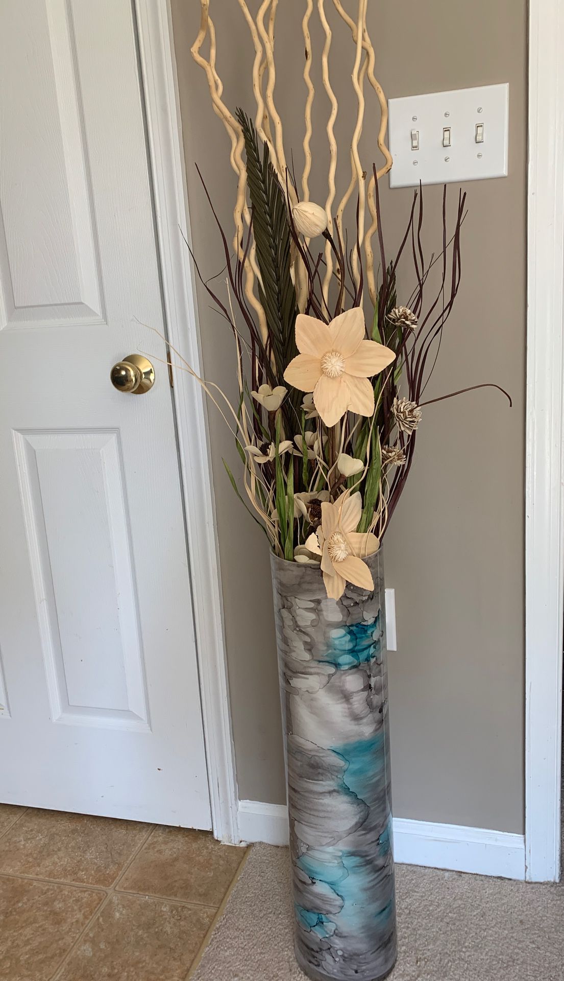 Faux paper flowers and stems in vase