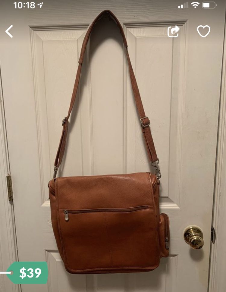 Mens genuine leather messenger bag. Multiple pockets inside and out. 12 inches wide, 14 tall without the hanger and 32 inches including the hanger. 5