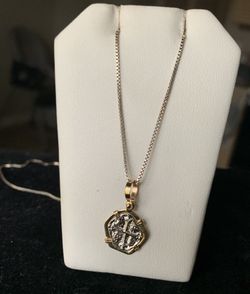 Atocha silver coin in gold bezel with silver chain.