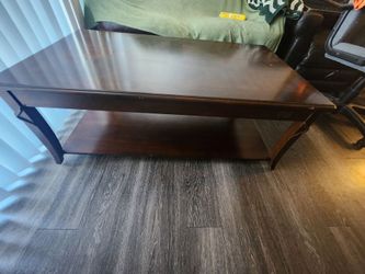Dark brown wood coffee table with a lower storage shelf.