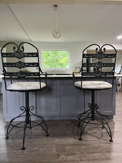 Two black metal bar stools Both for $300