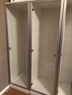 Tall white cabinets with glass door and glass shelves $100 each Total 3 cabinets