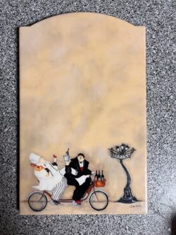 Decorative tile featuring a whimsical Parisian scene with chefs on a bicycle $20 cash only. Cross posted