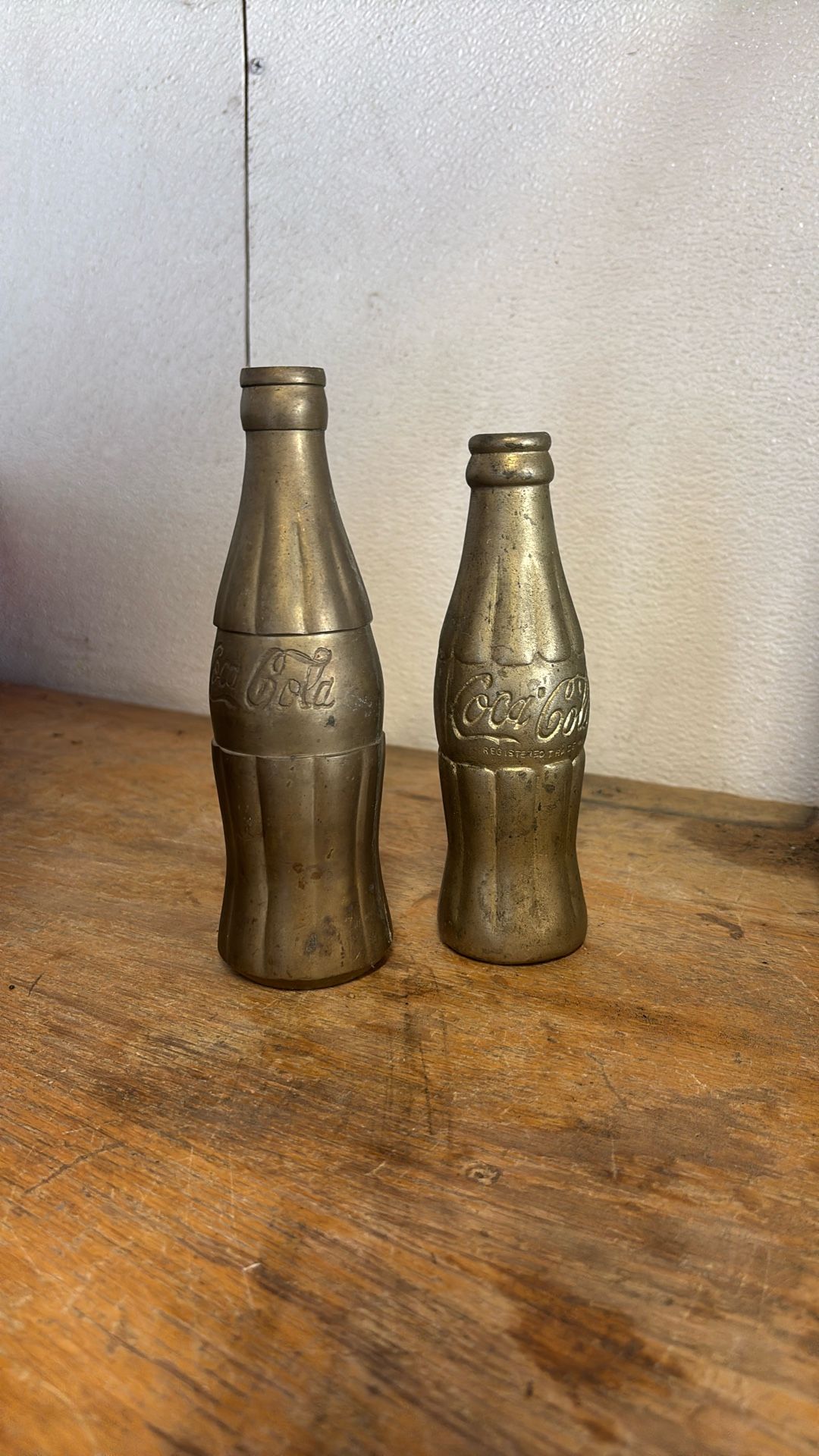 Two Vintage Brass Coca-Cola Bottles