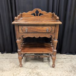 Dark Stained Wood Nightstand with Ornate Hardware