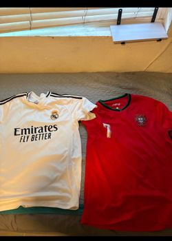 Selling soccer jersey white is large and red is XL