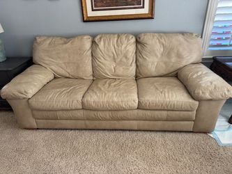 Tan leather sofa and loveseat set
