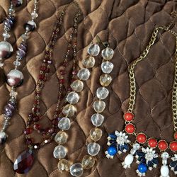 6 necklaces of beads, some of which are precious stones and crystals