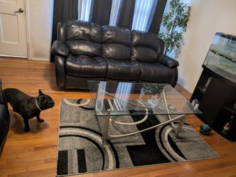 Black Leather Reclining Sofa, Coffee Table, and Area Rug