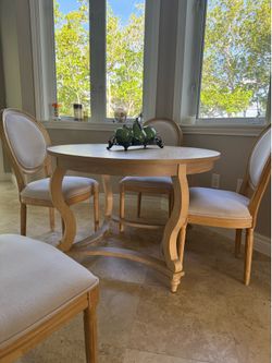 Beautiful French Country / Coastal Transitional dining set featuring a natural oak finish with upholstered Louis XVI–inspired dining chairs
