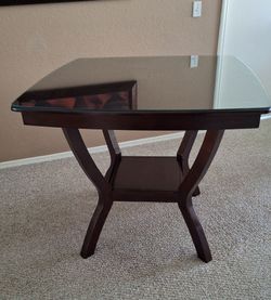 Brown solid wood dining table with a glass protection cover $25.00