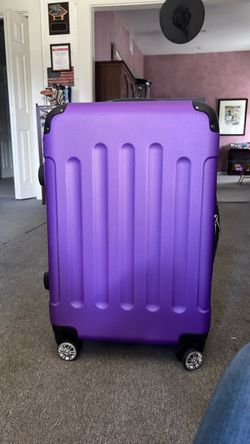 Luggage purple hard shell with spinning wheels