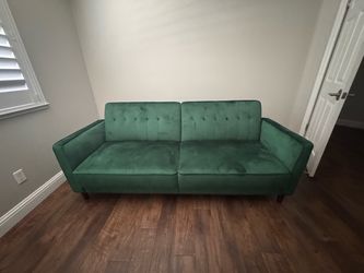 Beautiful green sofa that folds open into a full size bed!