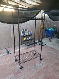 Clothing Rack  on wells  I ASK  $35.00