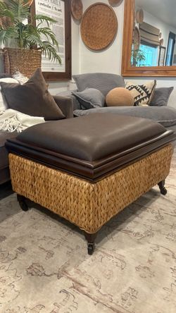 Large wicker and leather ottoman on castor wheels with storage