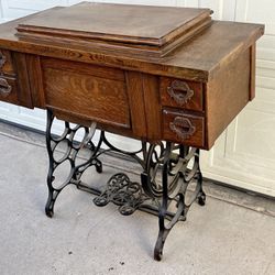 Antique Bruce Treadle Sewing Machine In Oak Cabinet, Cast Iron Base.